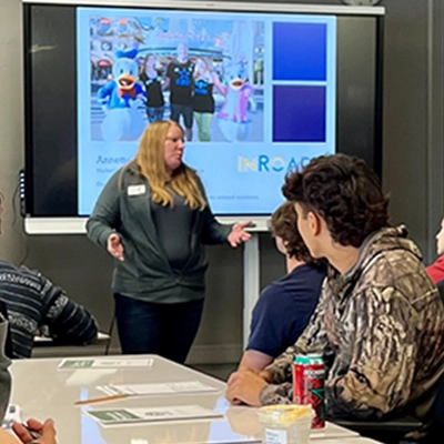 Annette teaching financial education to a group of people