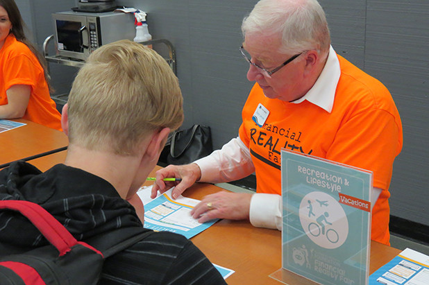 Students reviewing financials as part of financial reality fair