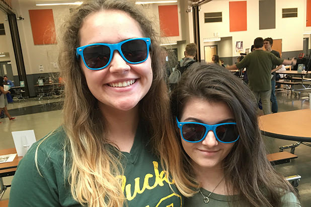 Students wearing sunglasses and participating in financial reality fair