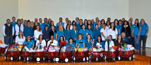 group photo of employees with wagons of toys