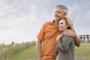 Portrait Of A Happy Mature Man Embracing Her Wife and Contemplate The Future