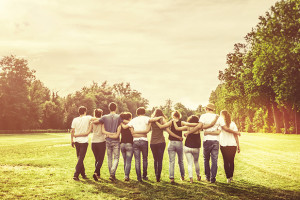 group of people with arms around one another