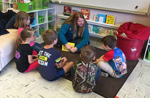 employee talking to school children