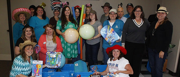 employees holding toys and other donations for MDA