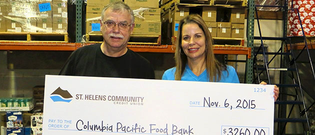 CEO Brooke Van Vleet presenting donation check to Casey at Columbia Pacific Food Bank