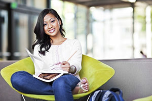 A shot of an Asian student studying on campus