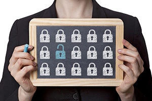 woman holding chalkboard sign with drawings of locks on it