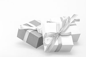 white background with white and gray wrapped gifts, tied with silver bows