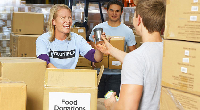 Volunteers Collecting Food Donations In Warehouse