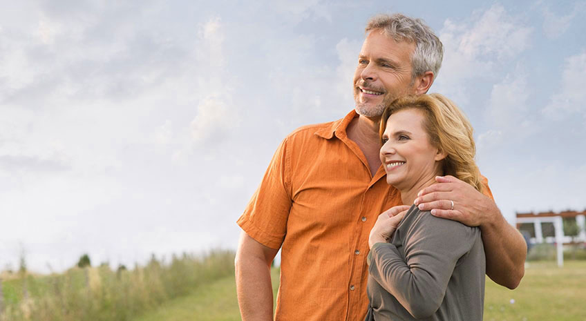 Portrait Of A Happy Mature Man Embracing Her Wife and Contemplate The Future