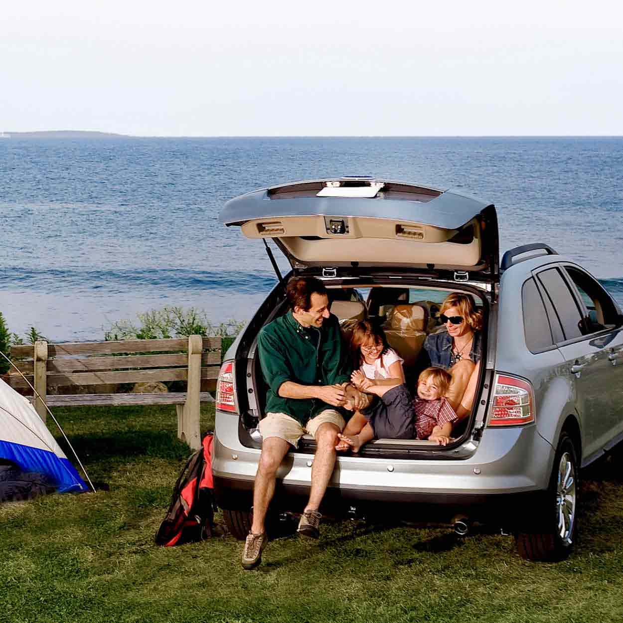 Family camping in car on water