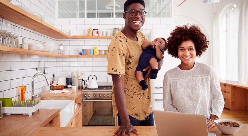 african american family in kitchen with laptop