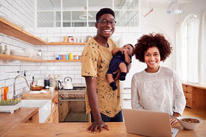 african american family in kitchen with laptop