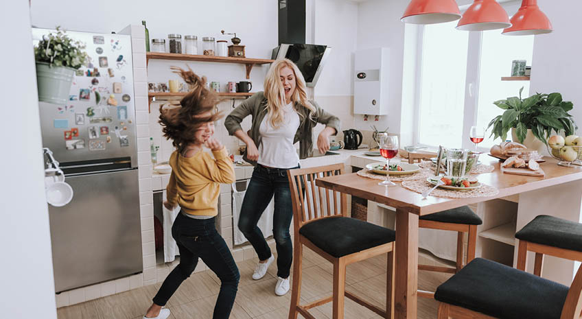 family dancing in kitchen