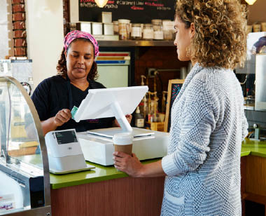 woman purchasing coffee at coffee shop