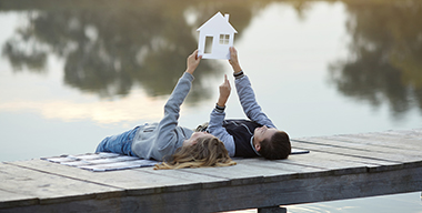 Happy couple of kids dream of a home. House concept