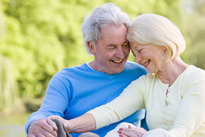 elderly couple sitting together smiling