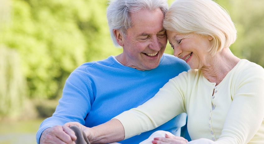 elderly couple sitting together smiling