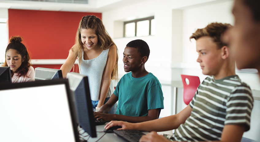 students using computer in classroom