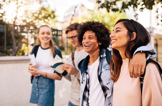 4 high school students walking studying