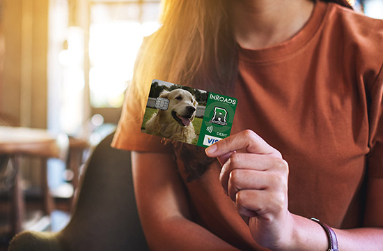 Closeup image of a woman holding and showing credit card