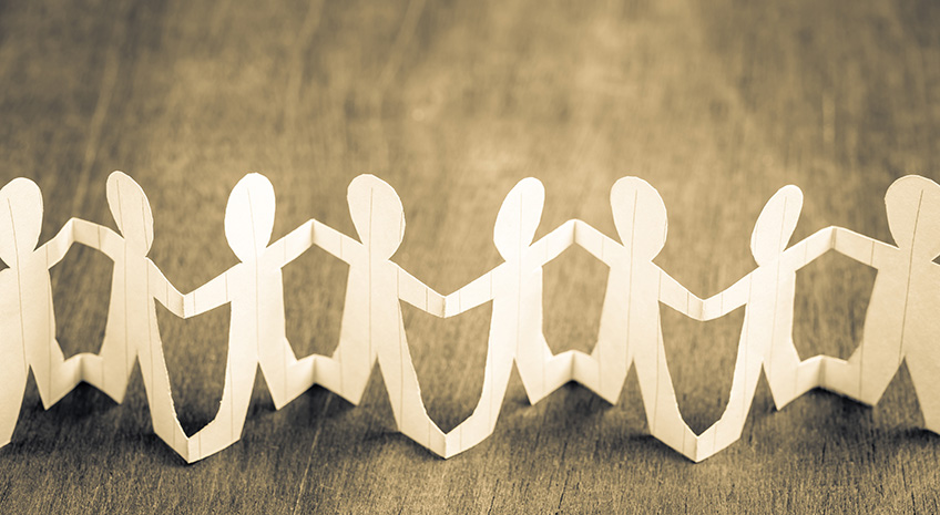 Paper human chain on wood background