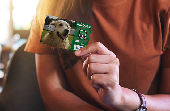 Closeup image of a woman holding and showing credit card