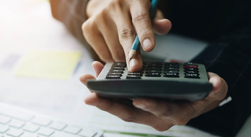 Close up Business woman using calculator and do math finance on workplace in office and business working background, tax, accounting, statistics and analytic research concept