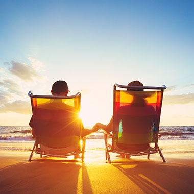 Retirement Vacation Concept, Happy Mature Retired Couple Enjoying Beautiful Sunset at the Beach