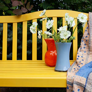 updated bench with yellow paint, quilt and flowers