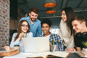 Studying together. College students preparing for classes in library