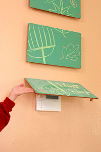 liftable chalkboard that hides things on your wall like electrical panels or switches