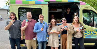group of male and female inroads employees outside holding ice cream with a local ice cream truck