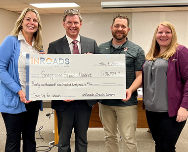 InRoads CEO and employee presenting a Team Up for Schools check to SHS faculty