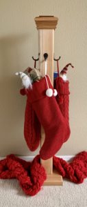 wooden post with hooks to hold up stockings without using a mantel