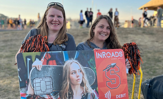 annette and erica at shs vs shhs game with large team up card