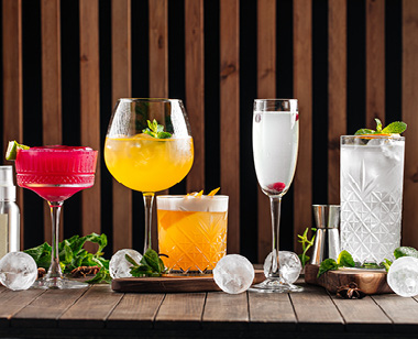 Side view on various refreshing alcoholic cocktail drinks