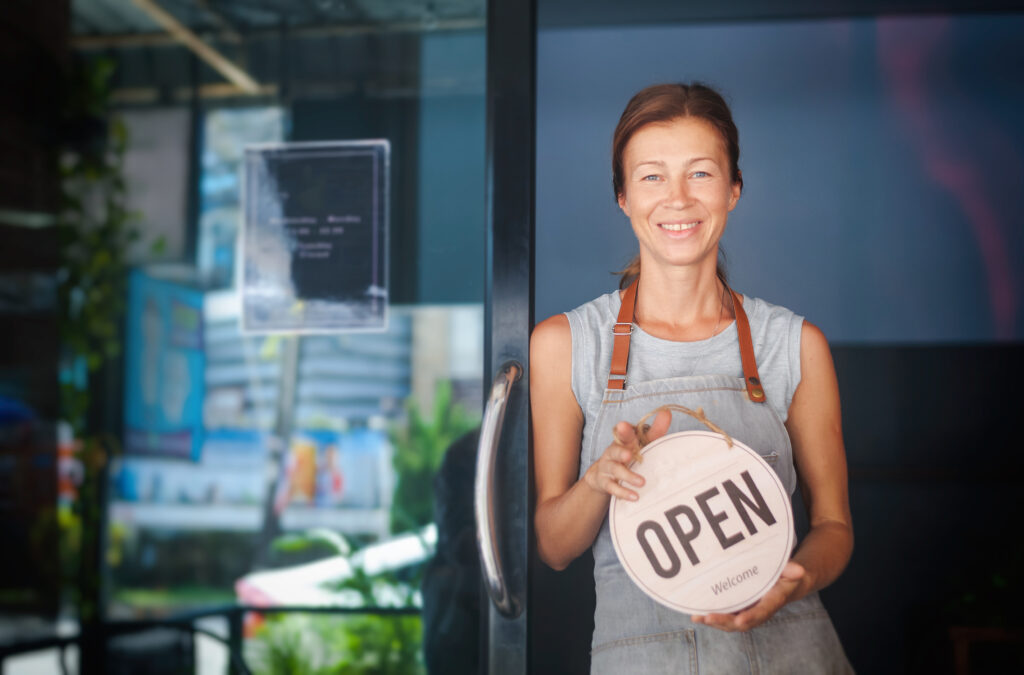 Business owner with open sign