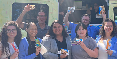 InRoads employees pose with ice cream in front of ice cream truck