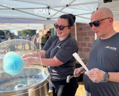 Dallas and Paige make blue cotton candy at community event
