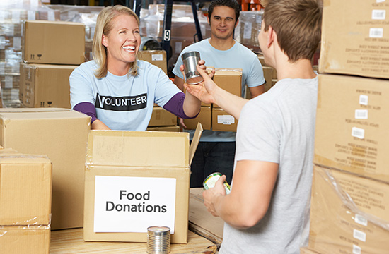 Volunteers Collecting Food Donations In Warehouse