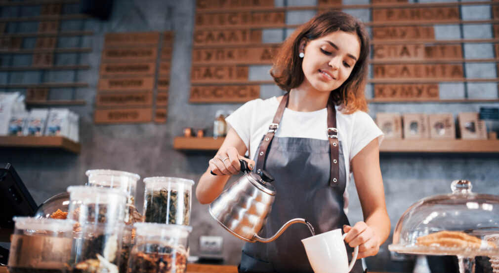 When you love your job. Young female cafe worker indoors. Conception of business and service