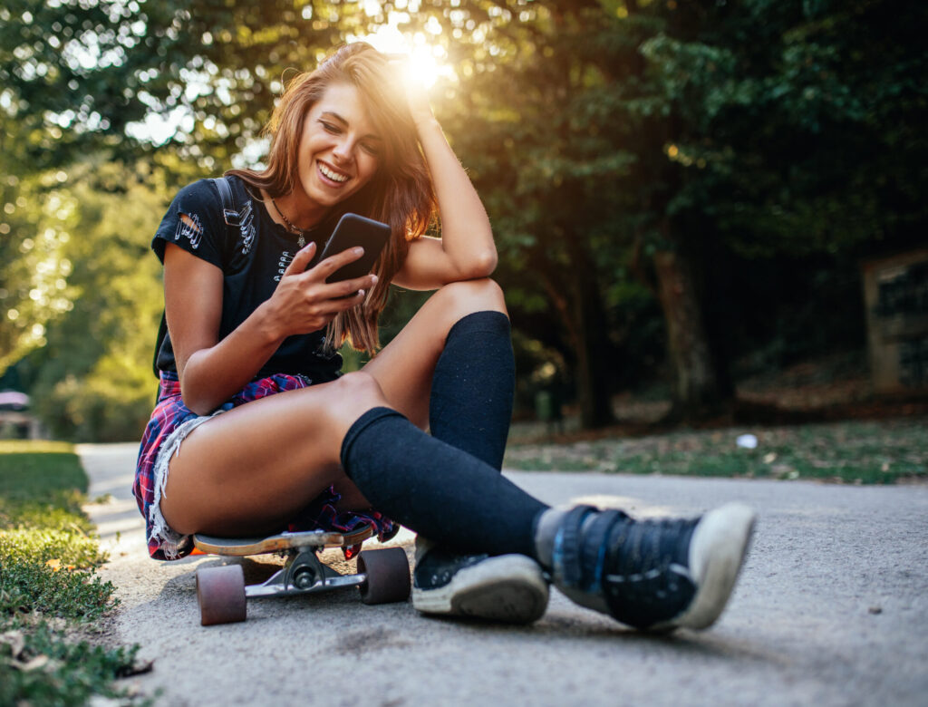 Young woman using phone outdoors