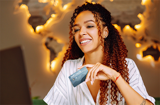 woman holding Explore Rewards Visa card