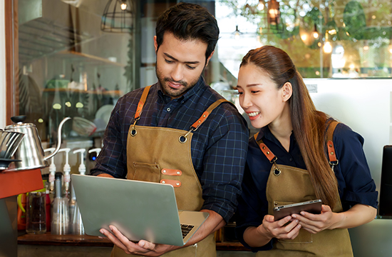 business owners looking at laptop