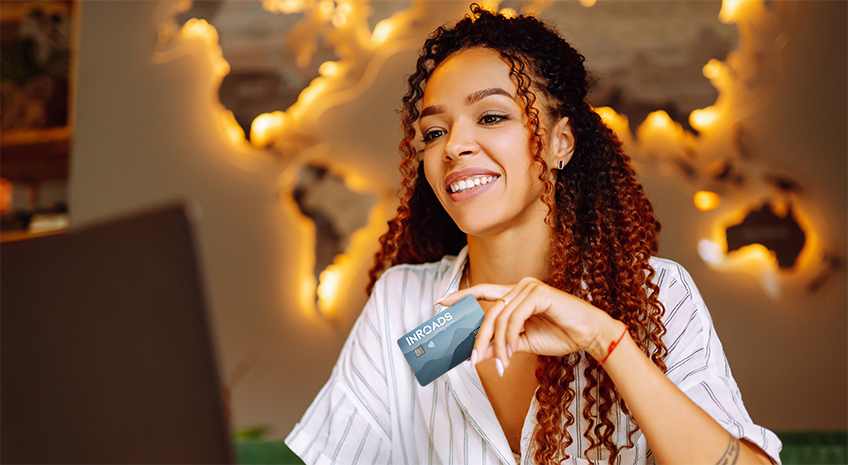 woman holding Explore Rewards Visa card