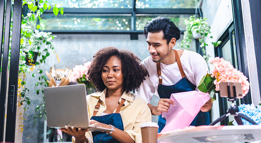 small business owners looking at computer